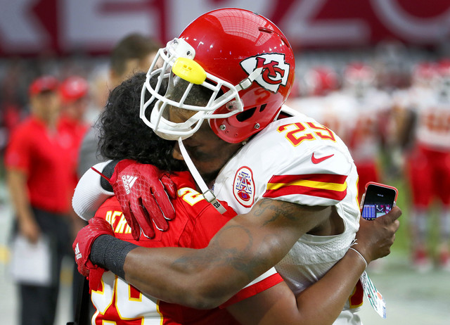 Kansas City Chiefs strong safety Eric Berry (29) hugs his mom, Carol Berry, prior to an NFL preseason football game against the Arizona Cardinals , Saturday, Aug. 15, 2015, in Glendale, Ariz. (AP Photo/Matt York)